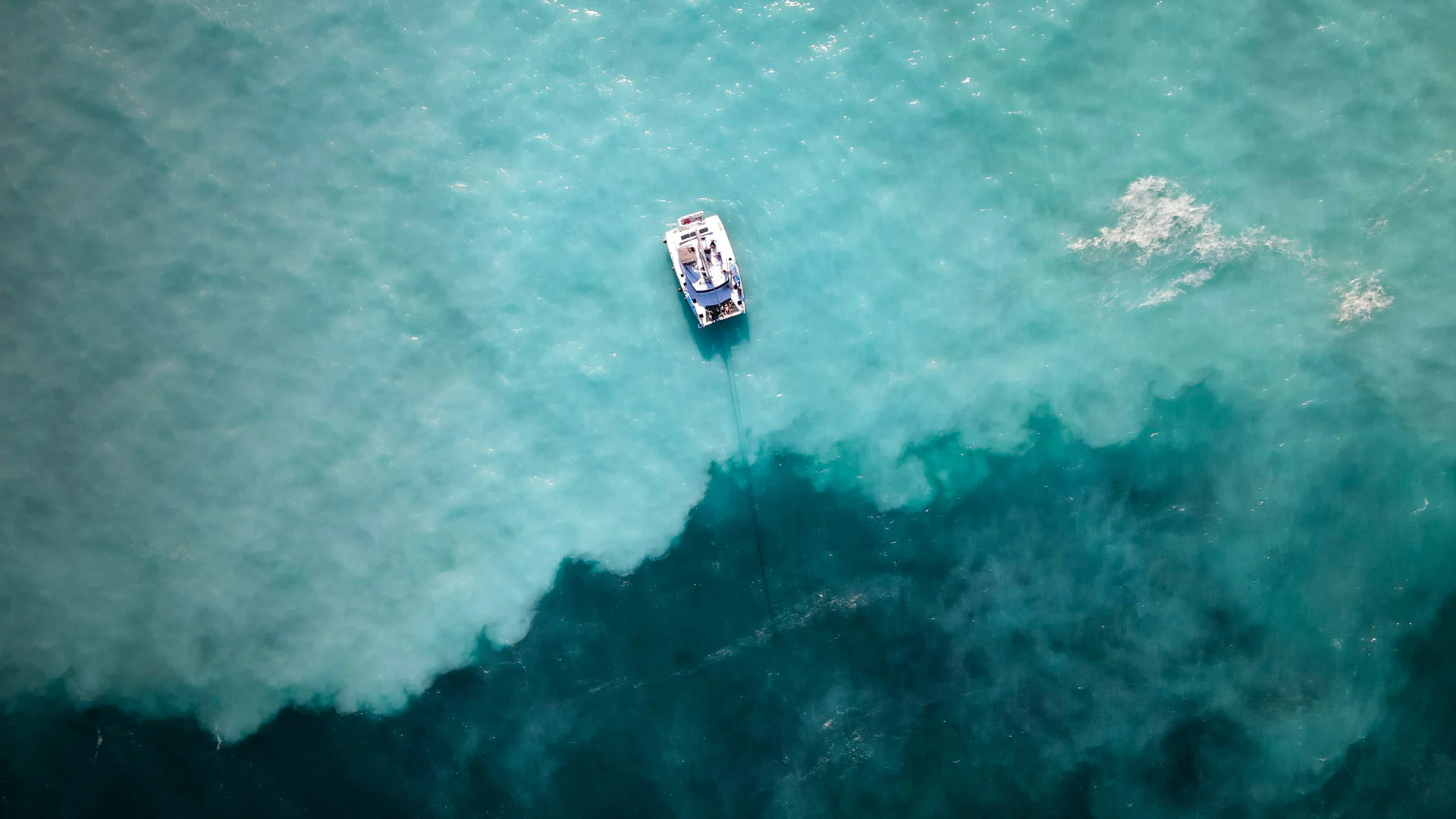 Aerial view of a catamaran on turquoise water